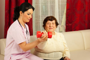 therapist woman helping senior to do exercise